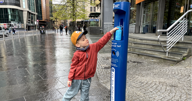 Finn Rush (4) refills his water bottle from Glasgow's newest Top Up Tap outside Buchanan Bus Station
