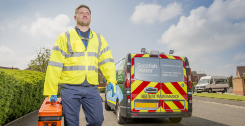Scottish Water employee walking beside van