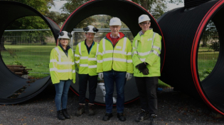 John Swinney and members of Scottish Water's Project Team in front of new sewer
