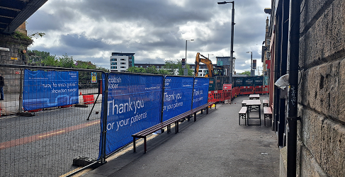 The work site is shown fenced off beyond the pavement on London Road