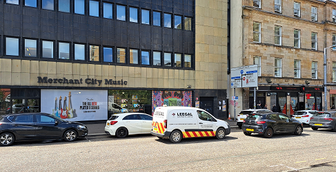This image shows parked vehicles on London Road in Glasgow