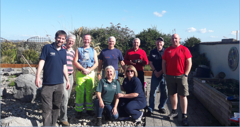Volunteers from Scottish Water and ESD spent a day painting, varnishing and weeding to help look after the village's Pocket Garden