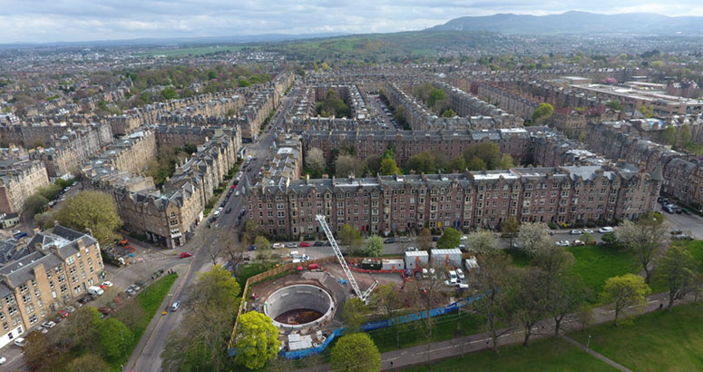 Drone aerial photo of Edinburgh with houses and hill in the distance