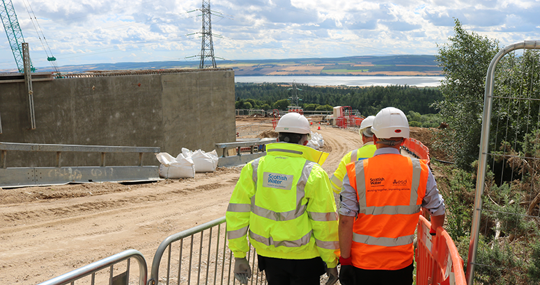 Representatives of Scottish Water and ESD survey the construction site