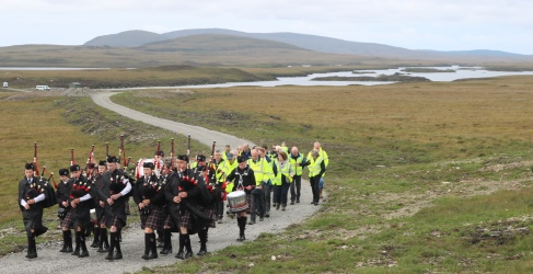 Sgoil Lionacleit Pipe Band with Loch Fada behind