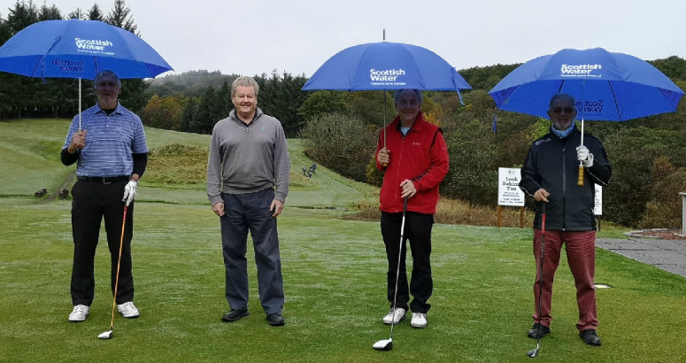 golfers sporting their umbrellas