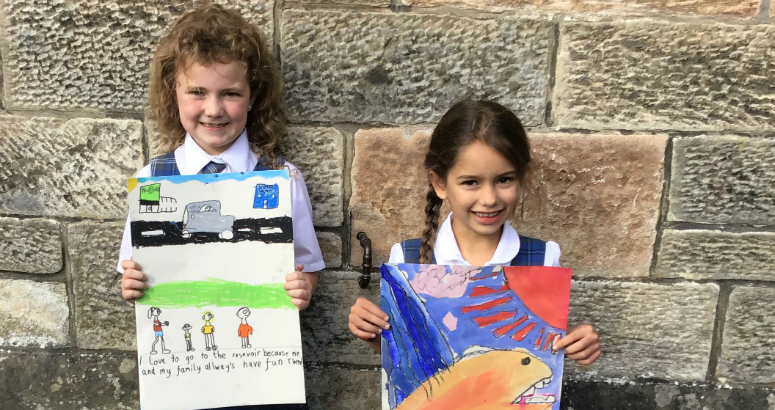 Pupils at MPS showing their artwork 