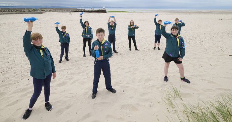 Members of the 1st Nairn Scouts with their refillable water bottles on the seaside town's East Beach