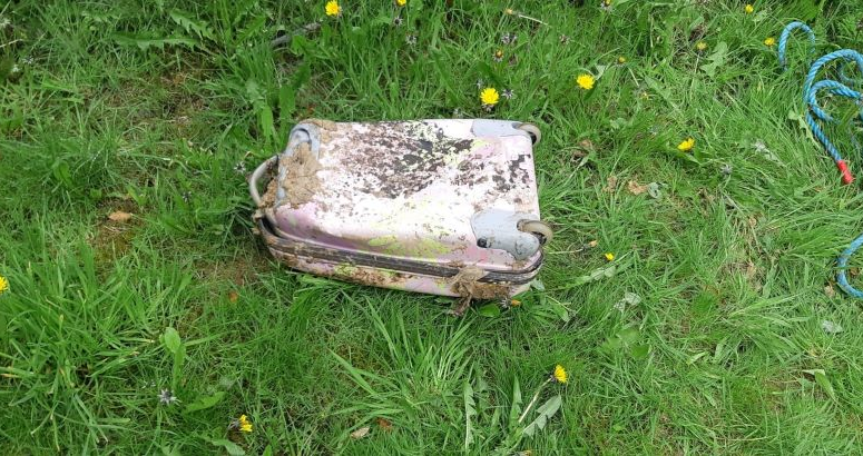 Pink suitcase pulled out of sewer
