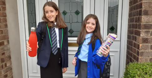 School girls holding water bottles
