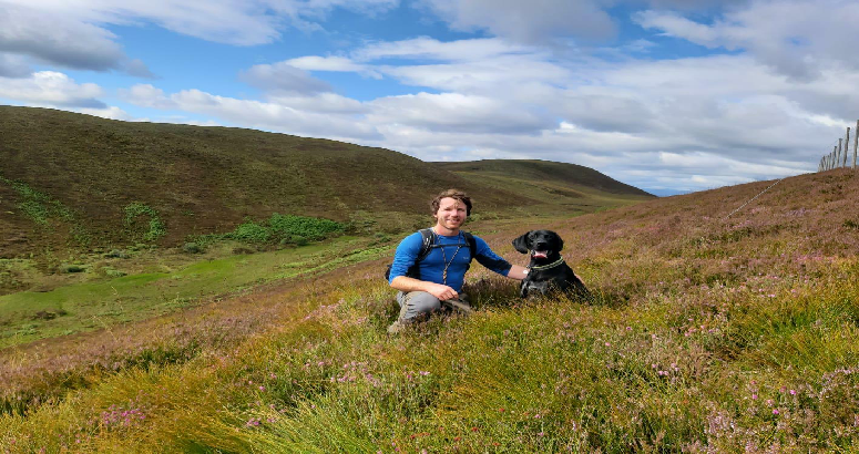 Adrian Burton pictured with his dog while out on a hilly walk.
