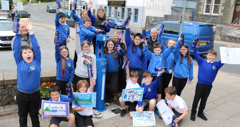 P6 pupils from Portree Primary School celebrate the launch of the town’s new Top up Tap in Somerled Square with representatives from Portree and Braes Community Council, Portree and Braes Community Trust and Skye Climate Action