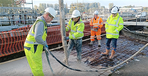 Construction workers pouring concrete