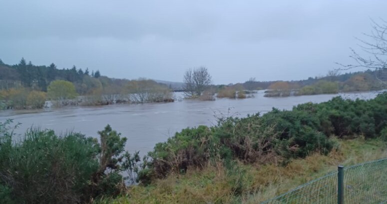 Inchgarth reservoir is under water with just the tops of trees poking above the water