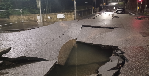 Hole in middle of the road caused by the force of the water Auchenhowie Milngavie Burst