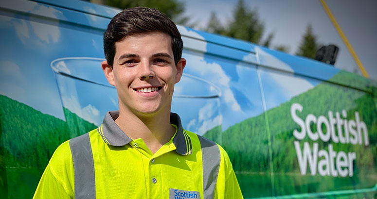 Young man in hi viz standing in front of Scottish Water Van