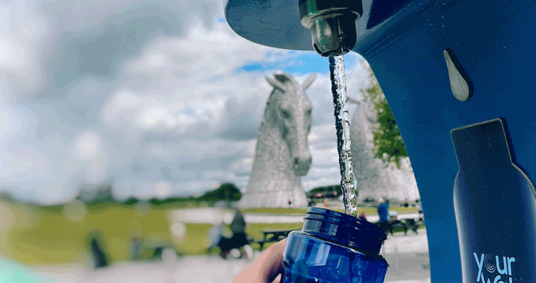 Blue water bottle under water fountain