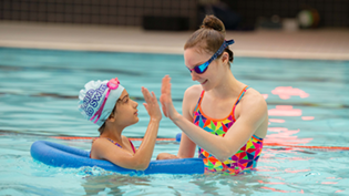 adult and child in swimming pool