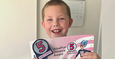 Young Jack Clews with his latest swimming certificate from Learn to Swim