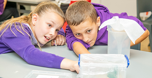 Generation H20 Water Cycle Workshop at St Pius Primary A young girl and boy from St Pius Primary School in Dundee busy with a water experiment at Scottish Water Generation H2O Water cycle workshop