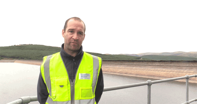 man in hi vis at a reservoir