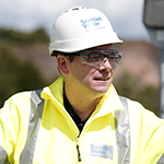 Scottish Water CEO Alex Plant in hard hat and hi vis jacket