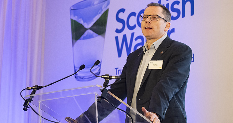 Scottish Water CEO Alex Plant talking at a lectern at a recent supply conference