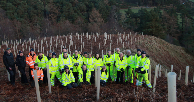 Volunteers from Scottish Water and Friends of the Pentlands pictured at the tree planting site overlooking Glencorse Reservoir