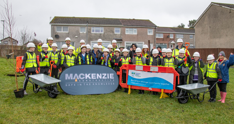 Children stand in front of banner
