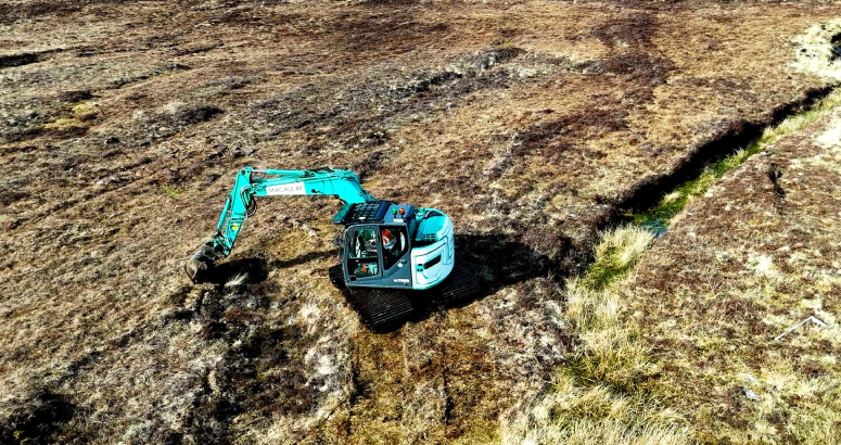An excavator at work as part of the peatland restoration project
