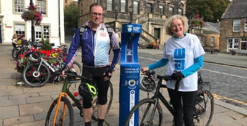 Two people at Top Up Tap with bikes 