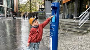 Finn Rush (4) refills his water bottle from Glasgow's newest Top Up Tap outside Buchanan Bus Station