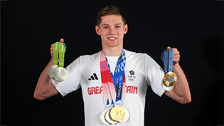 Olympic swimming champion Duncan Scott OBE with his eight medals