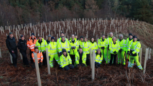 Volunteers from Scottish Water and Friends of the Pentlands pictured at the tree planting site overlooking Glencorse Reservoir