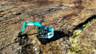An excavator at work as part of the peatland restoration project