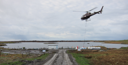 Helicopter transporting supplies to the Benbecula project Helicopter transporting supplies to the Benbecula project