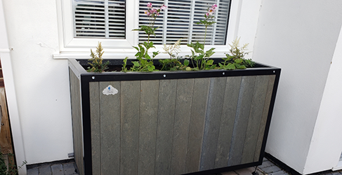 example of a planter installed on a property to capture roof run off